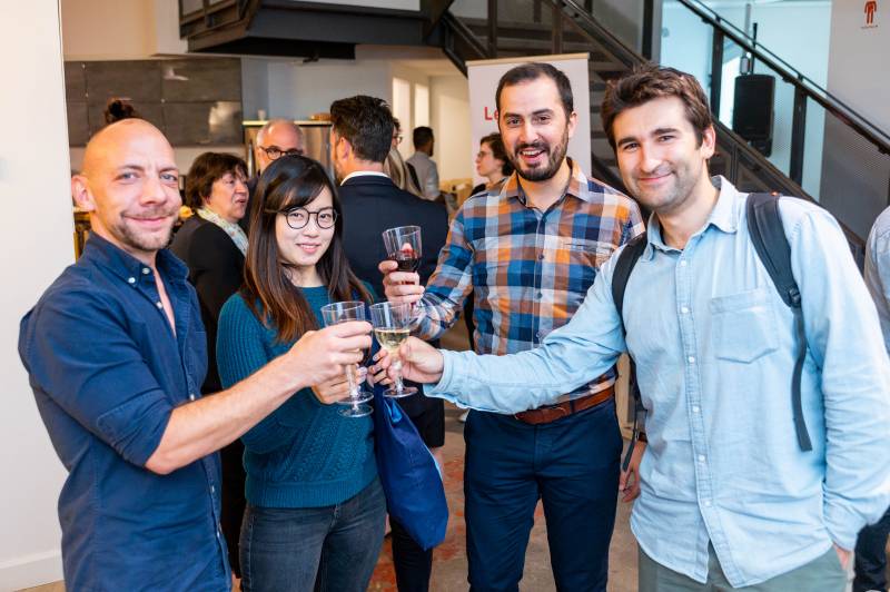 Evolving Web team members raising a glass at an A2C cocktail evenet