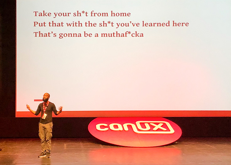 Farai on CanUX stage with presentation in background