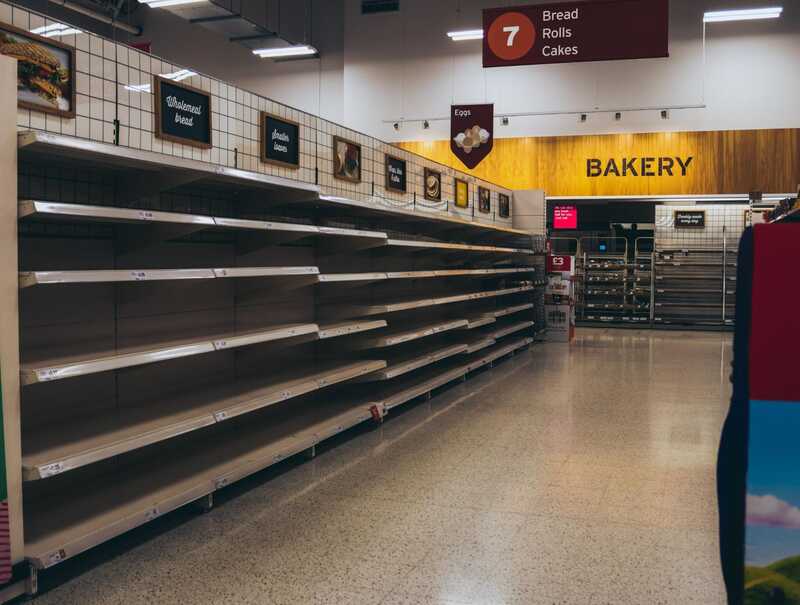 Alt text: A grocery store bakery section with empty shelves.