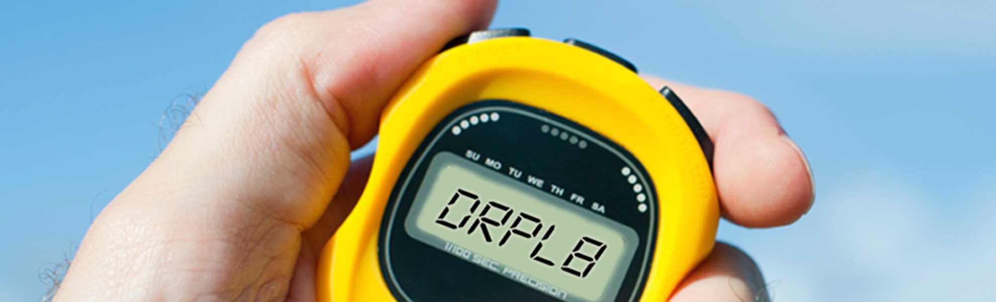 Hand holding stopwatch that says DRPL8