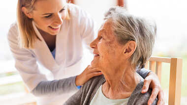 Elderly patient with a smiling doctor